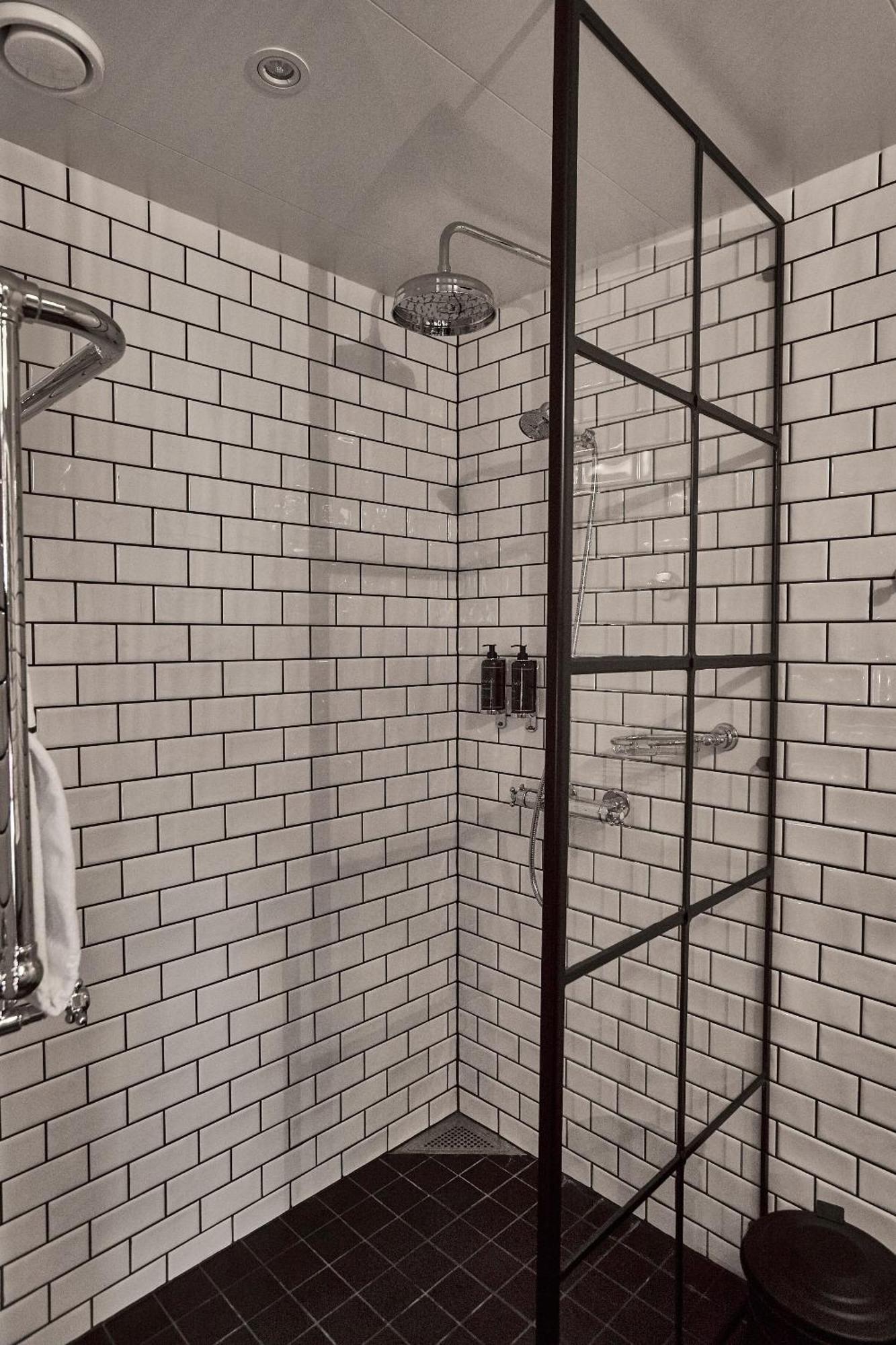 Steam Hotel Vasteras Exterior photo Subway tiles in a shower